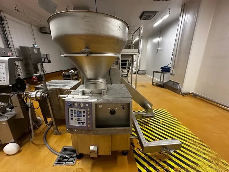 Food-industry filling/dosing machine in an ATEX-marked, yellow-black floor-striped hazardous zone