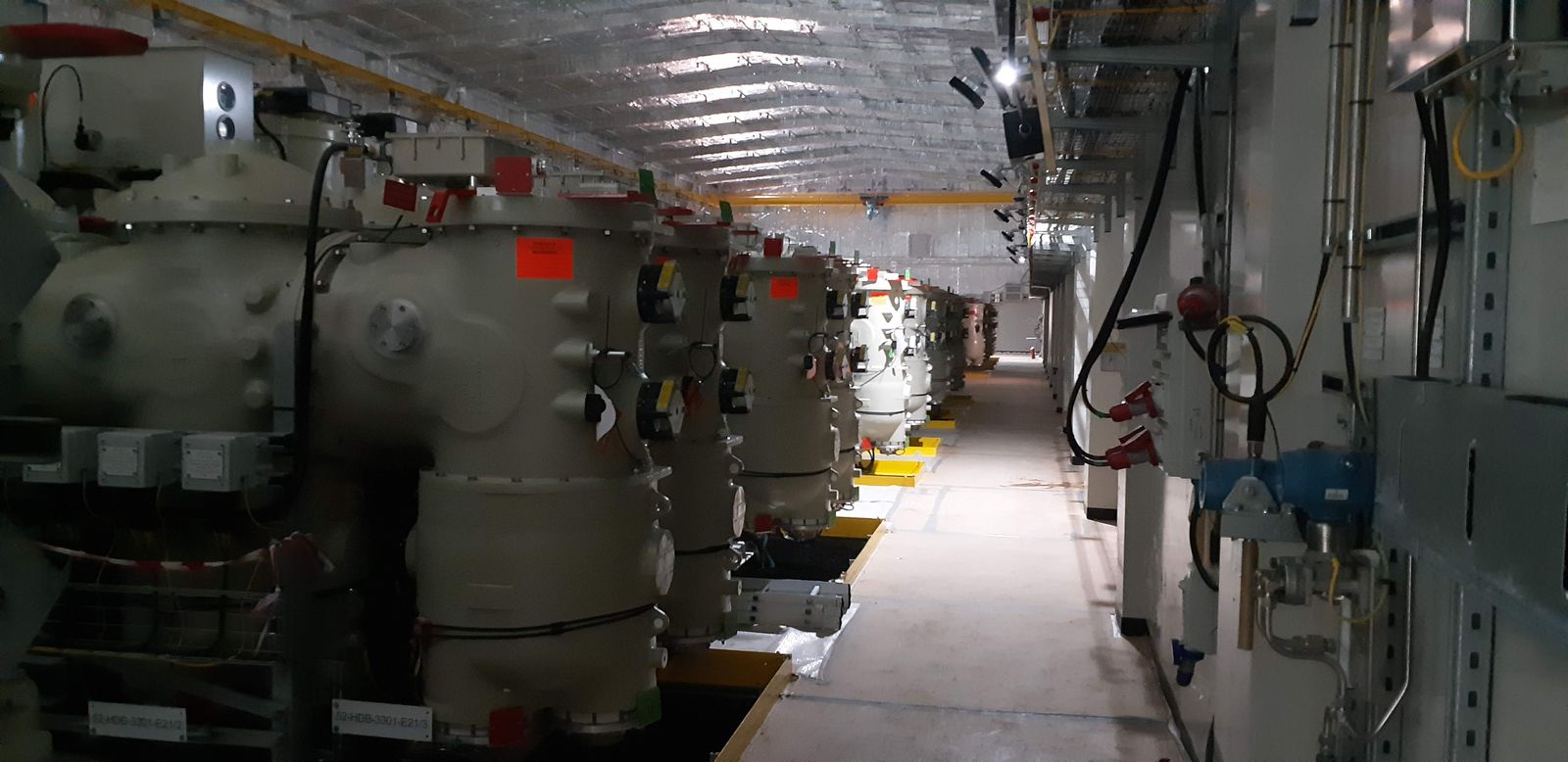 Row of gas-insulated (GIS) high-voltage switchgear in an industrial substation