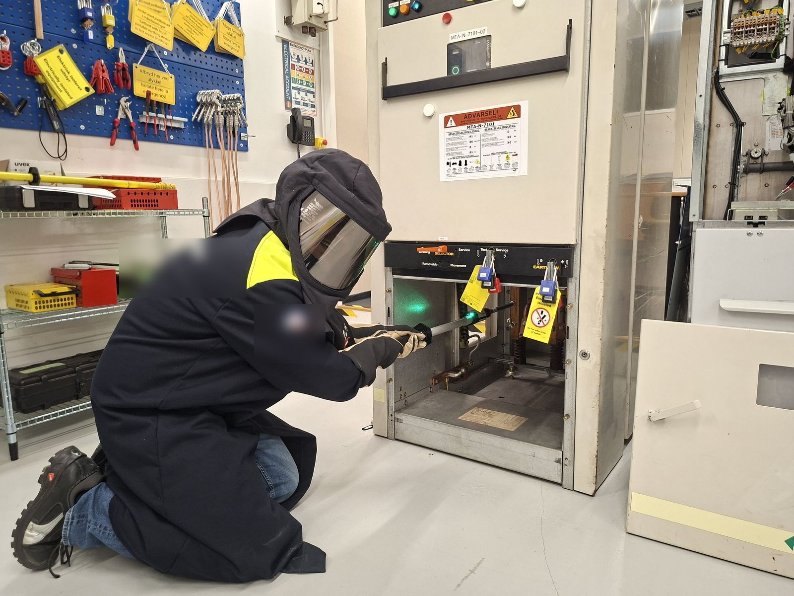 Electrical isolation and earthing on HV switchgear in arc-flash PPE, locked and tagged