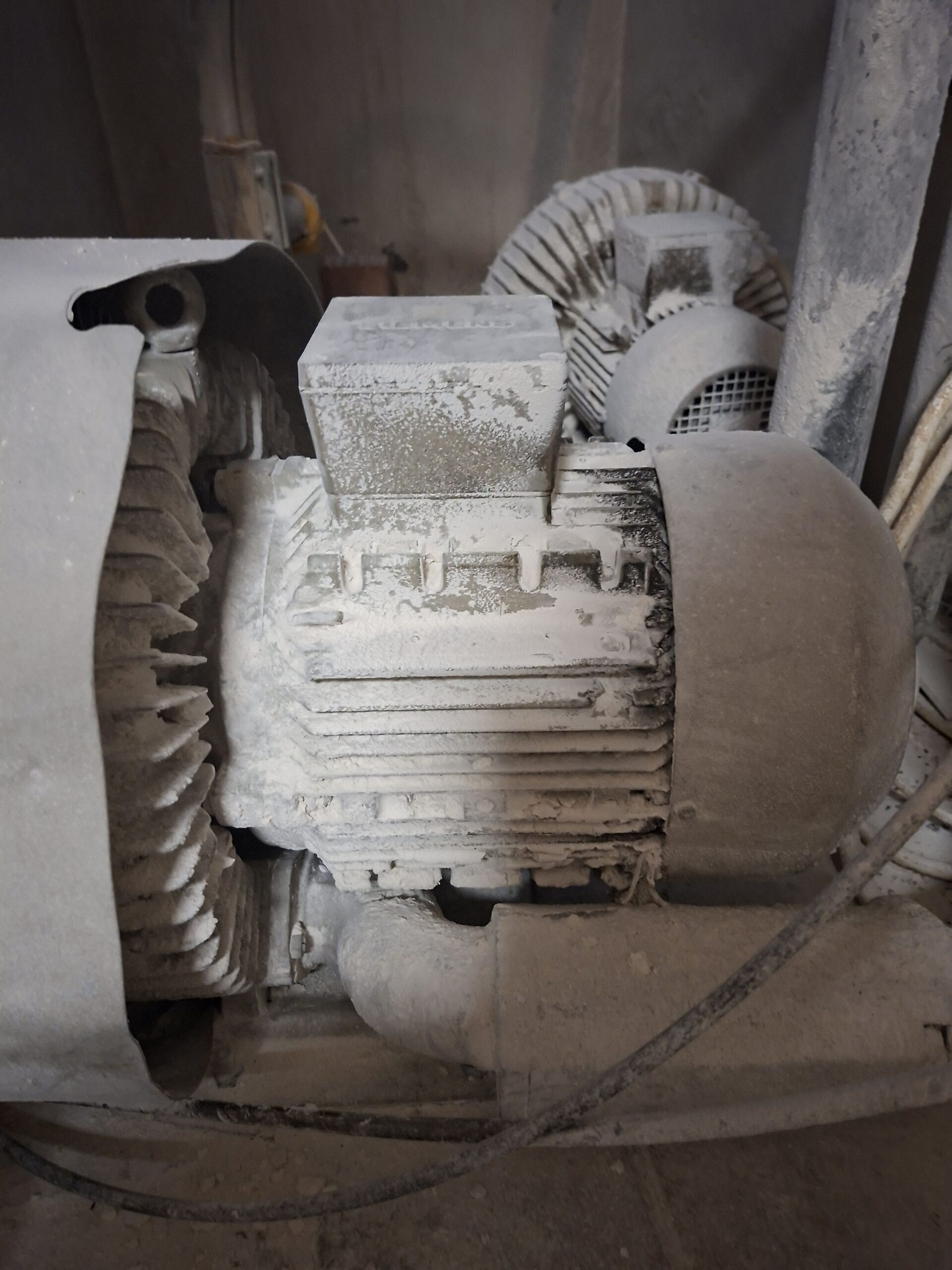 Thick dust build-up on an electric motor – ATEX dust explosion hazard